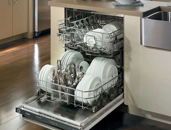Technician inspecting a residential dishwasher