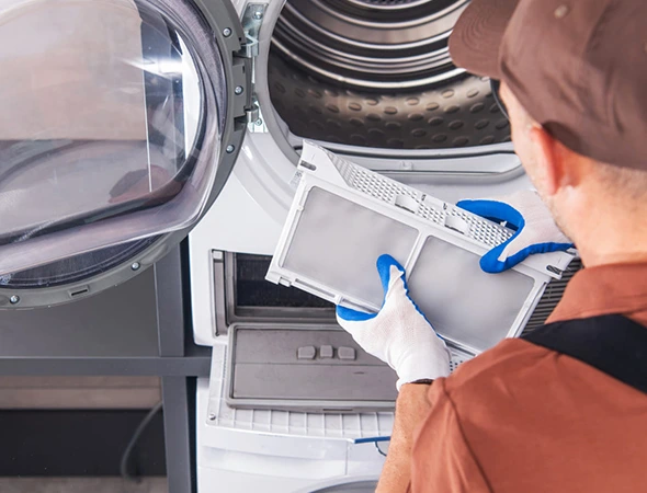 Dryer repair technician inspecting a clothes dryer in Meridian Idaho