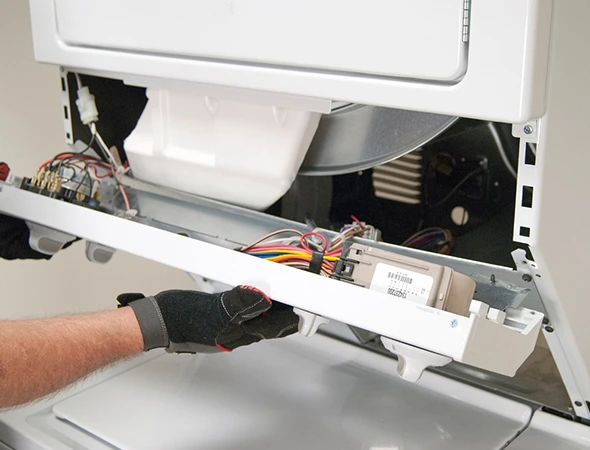 Technician troubleshooting a residential dryer