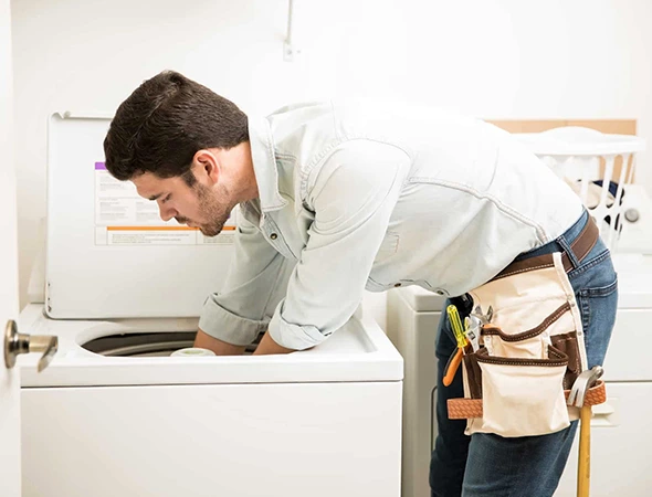 Affordable Appliance technician repairing a clothes dryer