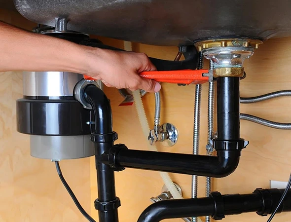 Technician inspecting a residential garbage disposal