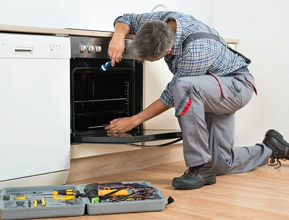 Affordable Appliance technician repairing an electric oven