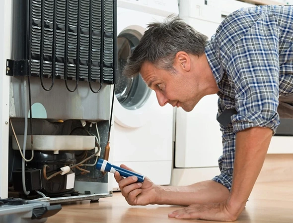 Affordable Appliance technician repairing a home refrigerator