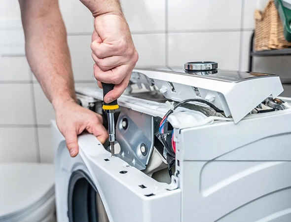 Technician repairing a front load washer in Meridian ID
