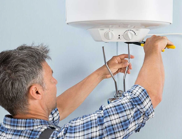 Technician inspecting a residential water heater