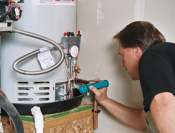 Affordable Appliance technician repairing a home water heater